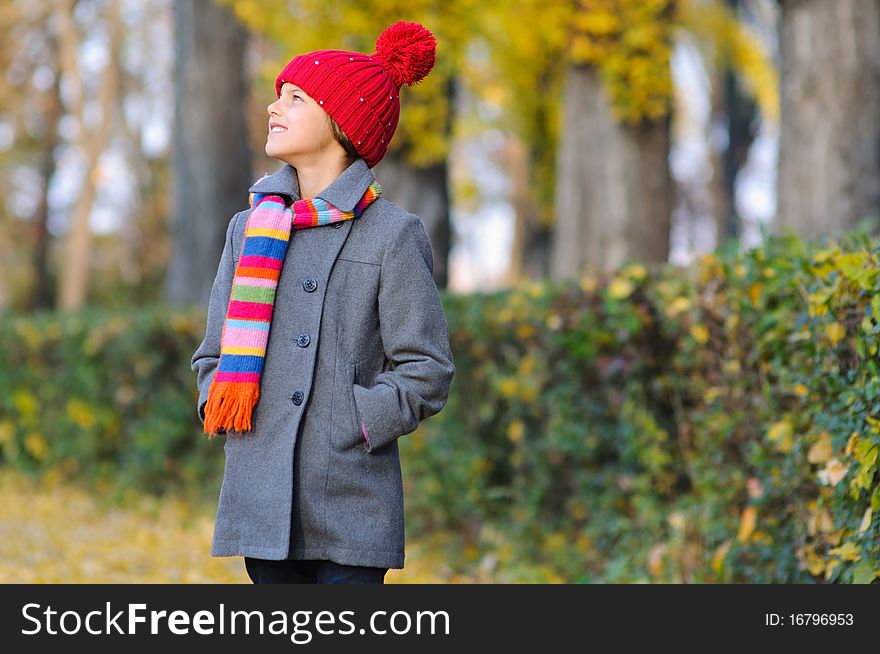 Little Miss. Pretty cute girl walks in autumn park