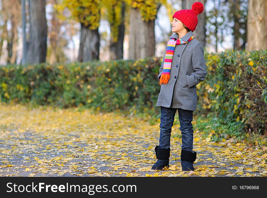 Little Miss. Pretty cute girl walks in autumn park