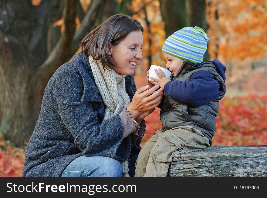 Little Cute Boy Drinks Tea With Her Mother