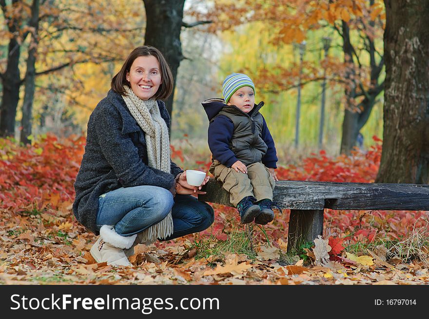 Boy drinks tea with her mother