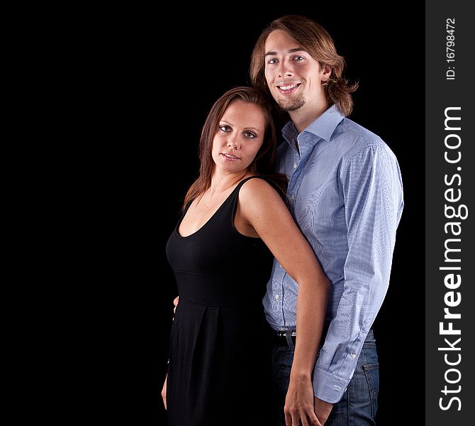 Young cute couple with long hair over black background. Young cute couple with long hair over black background.