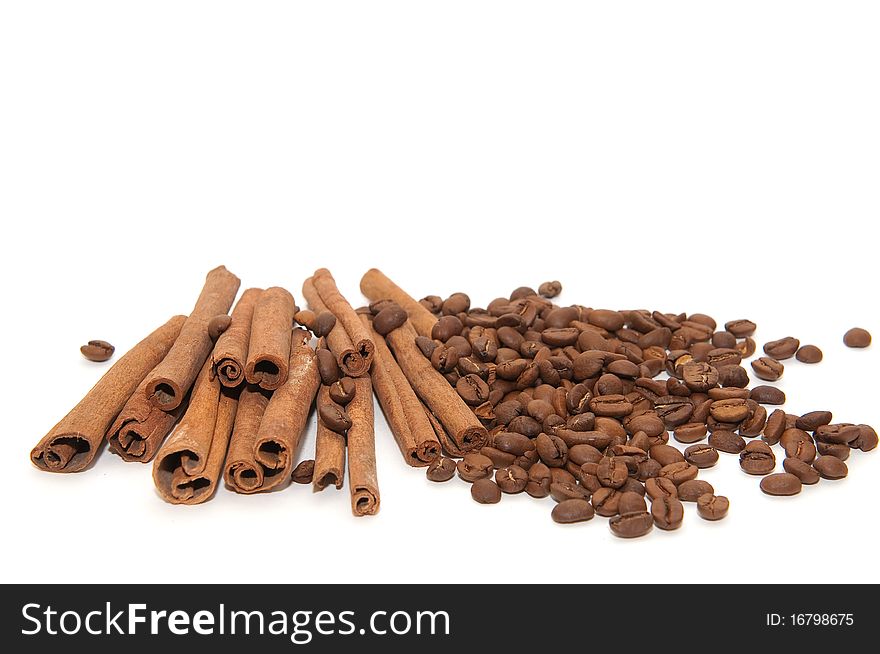 Cinnamon sticks and coffee beans on white background. Cinnamon sticks and coffee beans on white background