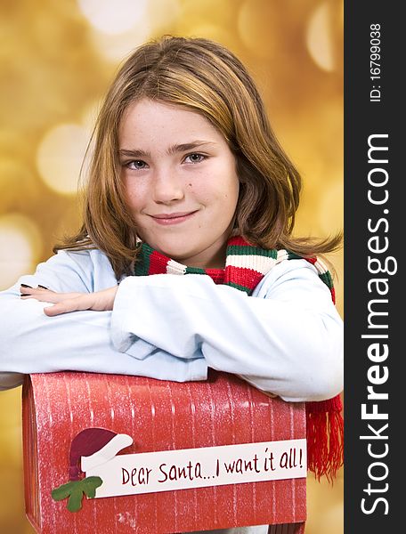 Young girl posing over a mailbox for letter to Santa. Young girl posing over a mailbox for letter to Santa