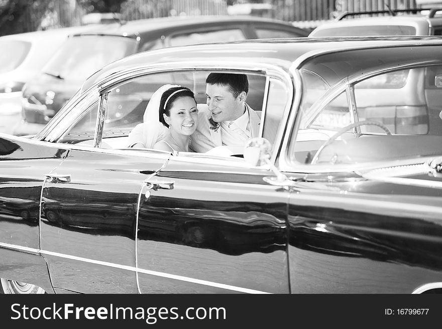 Newlywed couple, groom and bride, in car. Newlywed couple, groom and bride, in car