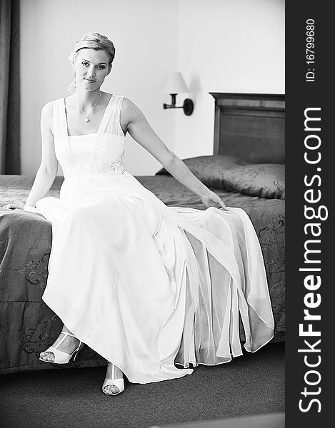 Beautiful stylish bride in white dress in room. Beautiful stylish bride in white dress in room
