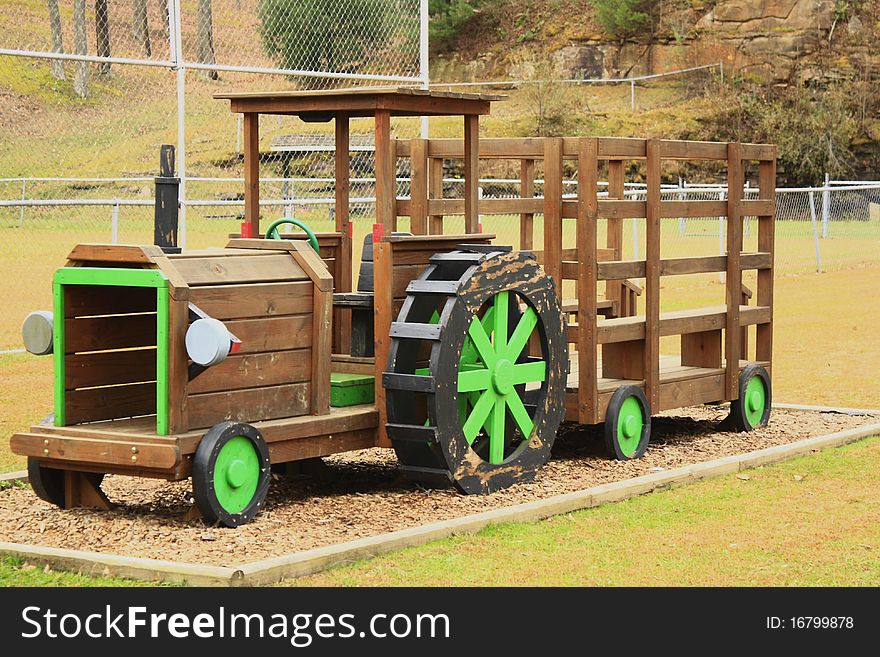 Wooden tractor in a playground. Wooden tractor in a playground