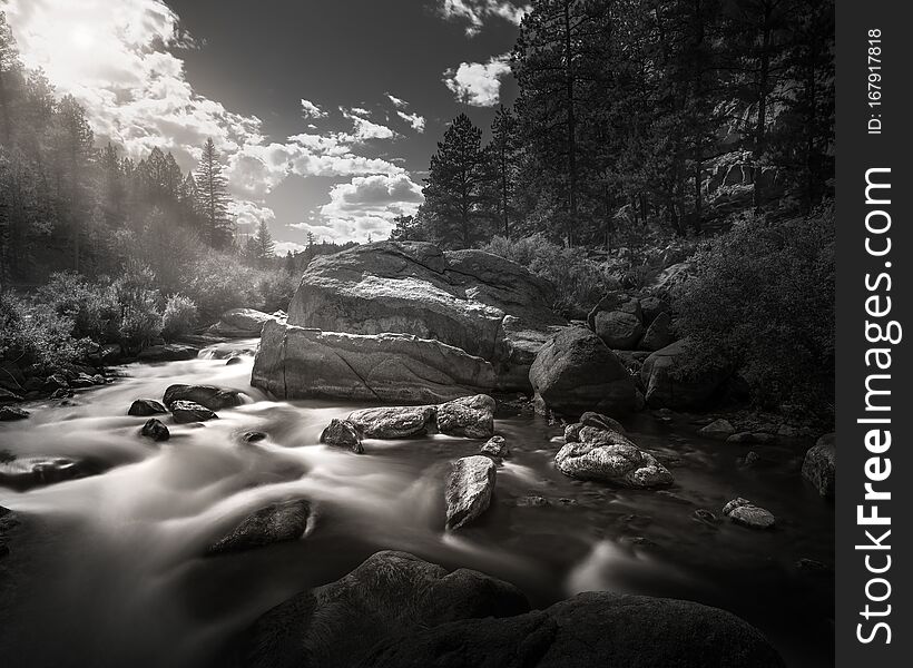 Black and white scene of a mountain river in the Rocky Mountains of Colorado. This is a long exposure so the river is smooth and silky looking. Black and white scene of a mountain river in the Rocky Mountains of Colorado. This is a long exposure so the river is smooth and silky looking.