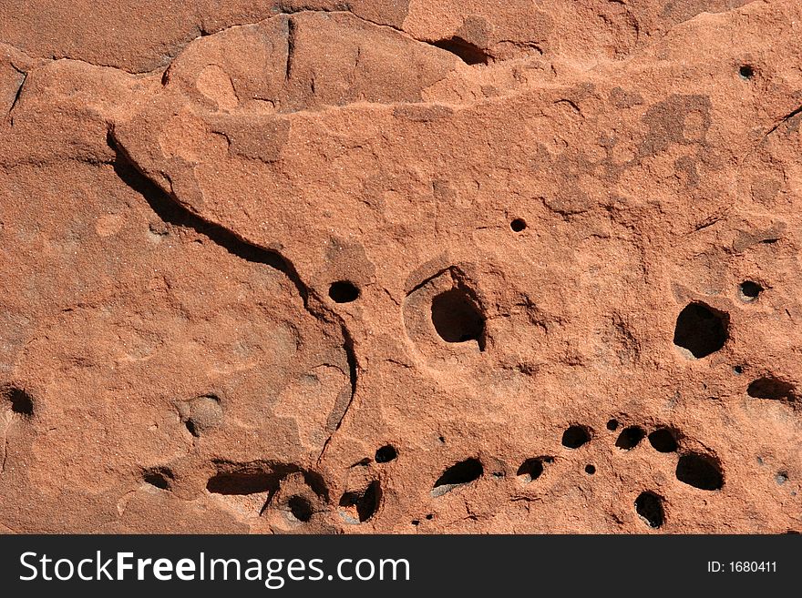 Red rock with holes textured background. Red rock with holes textured background