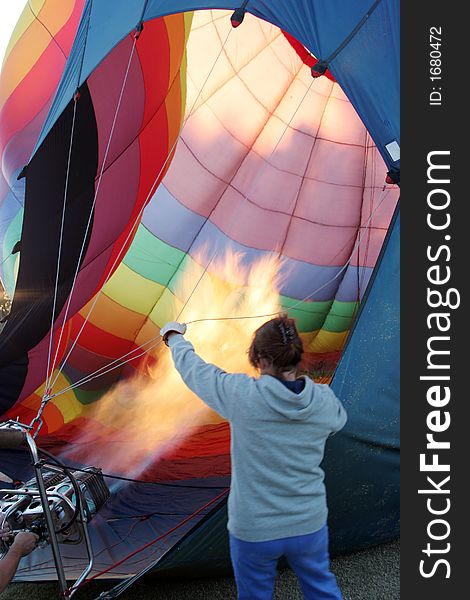 Woman preparing a colorful hot air balloon at the festival