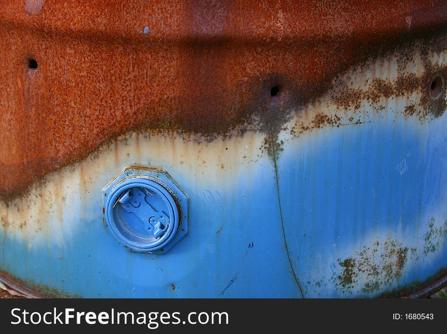 Rusty oil barrel with paint left on cap