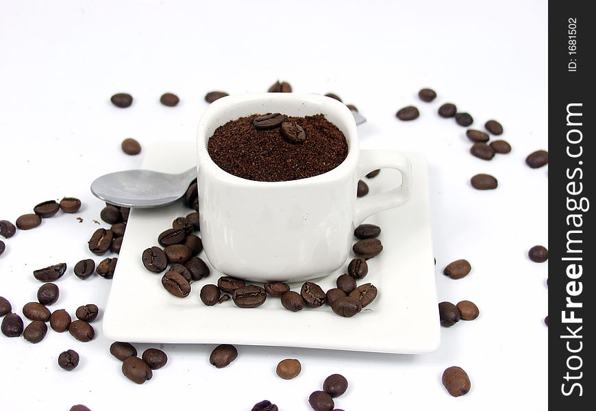 White coffe cup with black and brown beans on white background