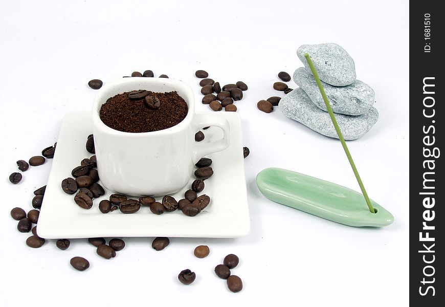 White coffe cup with black and brown beans on white background