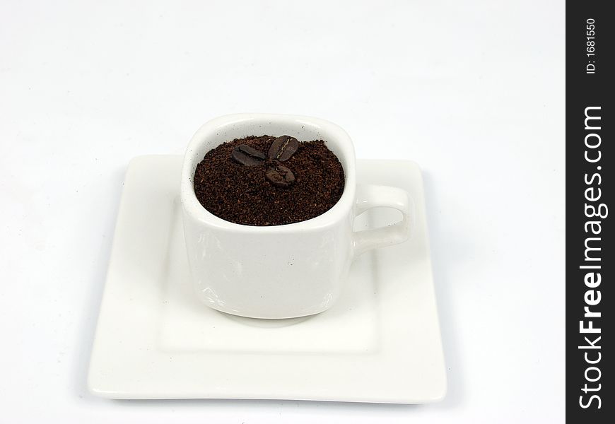 White coffe cup with black and brown beans on white background