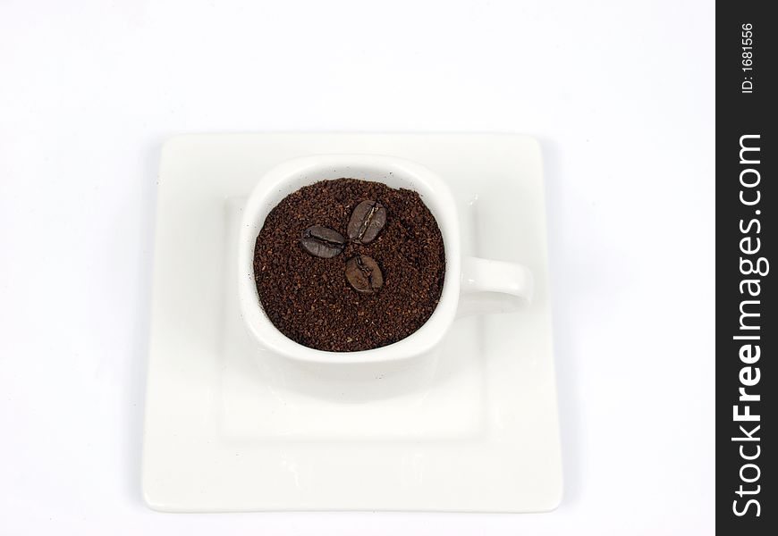 White coffe cup with black and brown beans on white background