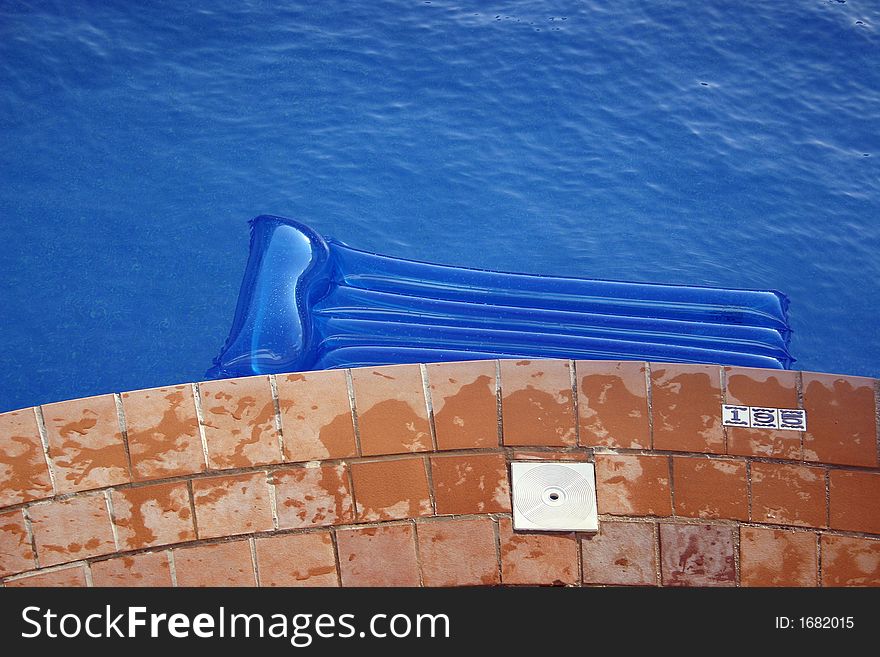 Blue inflatable lilo on a pool. Blue inflatable lilo on a pool