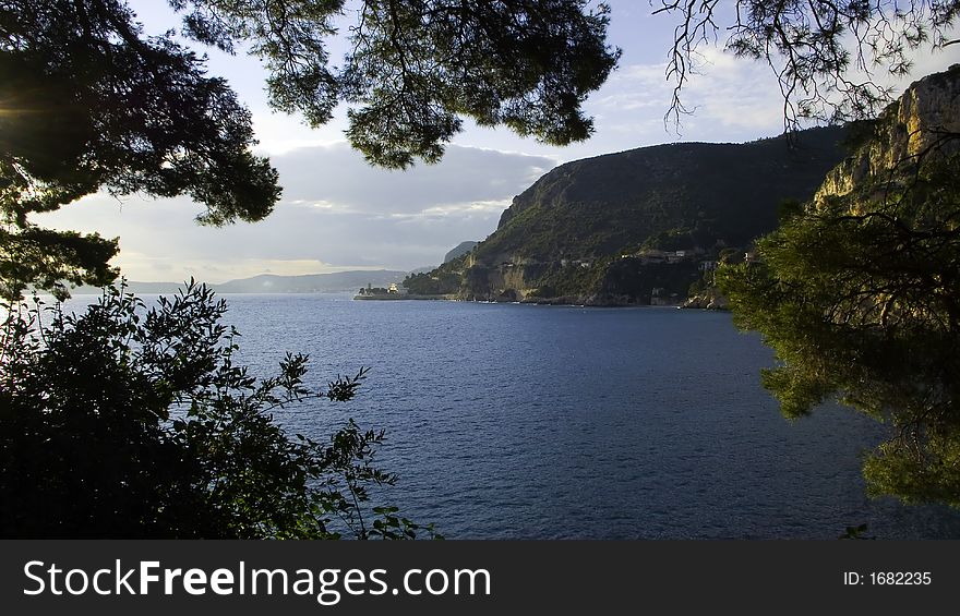 See through the trees of the bay of Beaulieu from Cap d'ail