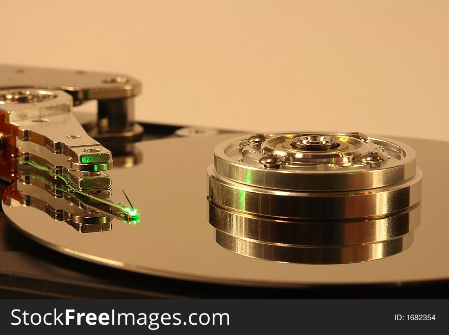 Internals of a hard disk, under green laser light. Internals of a hard disk, under green laser light.