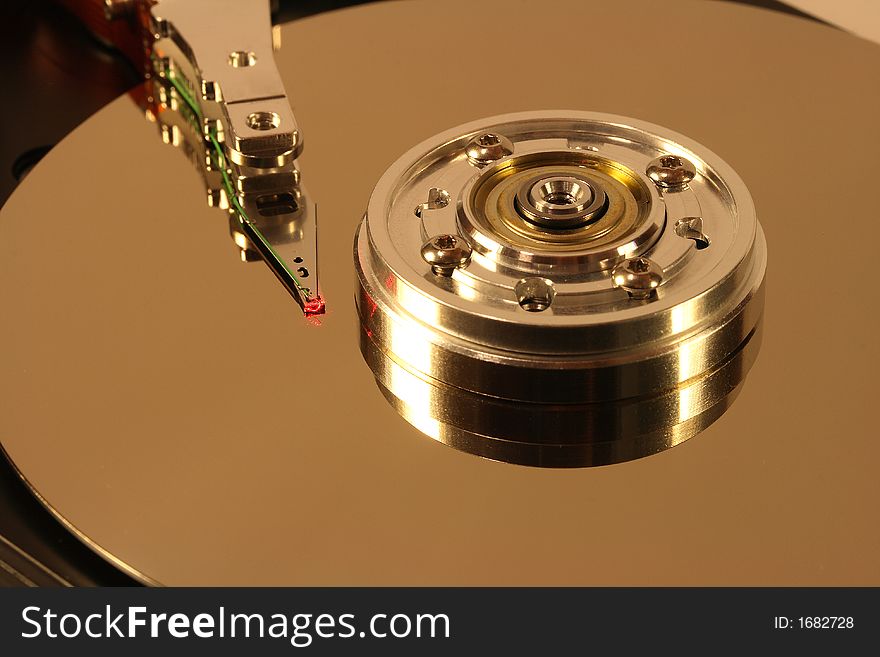 Internals of a Hard Disk under a red laser light. Internals of a Hard Disk under a red laser light.