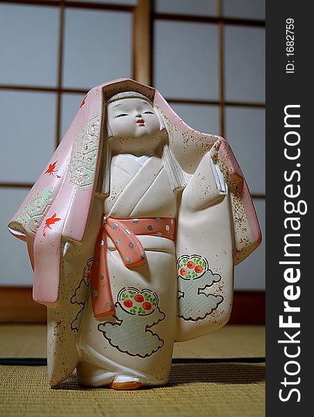 Traditional Japanese Statuette on the Mat. Traditional Japanese Statuette on the Mat