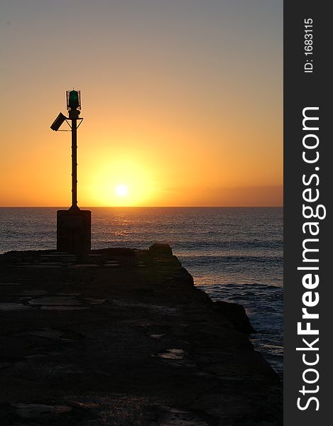 Sun coming up over the Indian Ocean in the East on the Eastern Cape coastline of South Africa from the Port Alfred, East Bank pier. Sun coming up over the Indian Ocean in the East on the Eastern Cape coastline of South Africa from the Port Alfred, East Bank pier