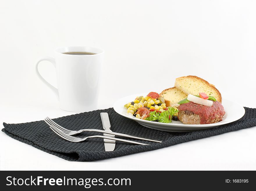 Ground turkey patty topped with seasoned tomato sauce and garnished with red and green pepper and onion, accompanied by a season corn,black bean and pepper vegetable, garlic bread and coffee.