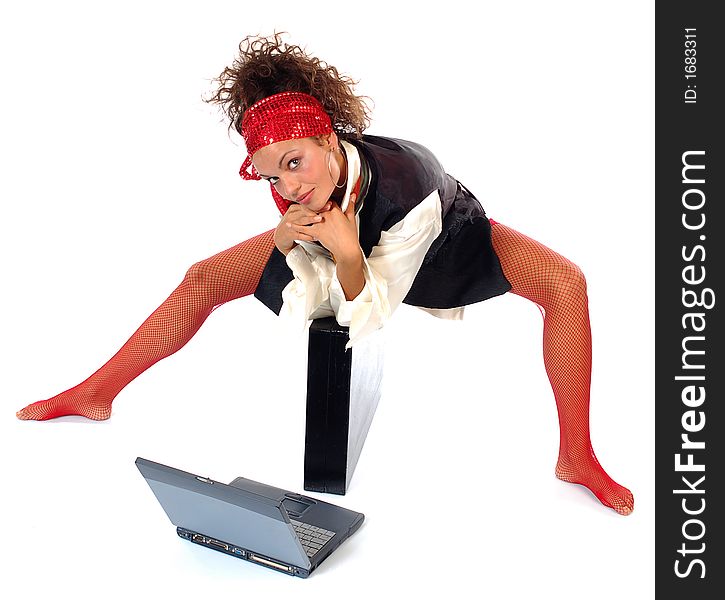 Happy businesswoman with laptop sitting on briefcase