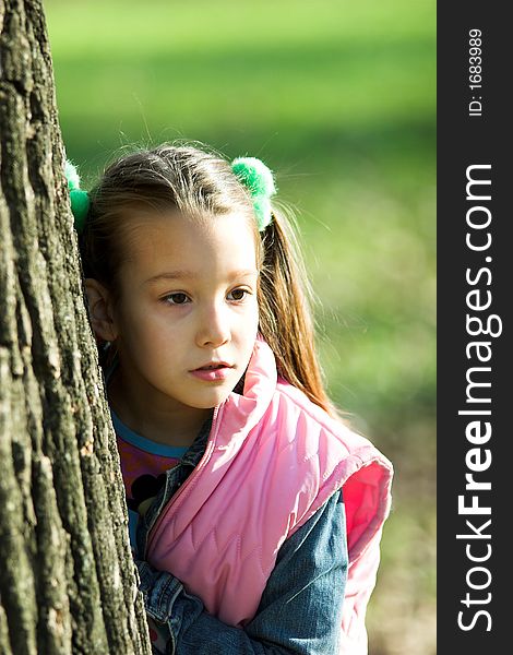 Portrait of little pretty girl in the park