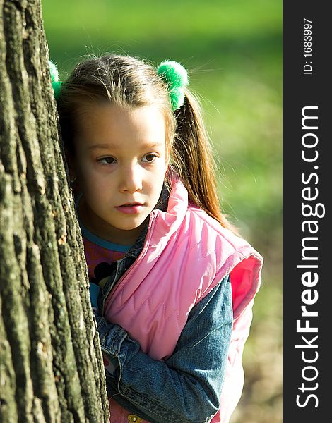 Portrait of little pretty girl in the park