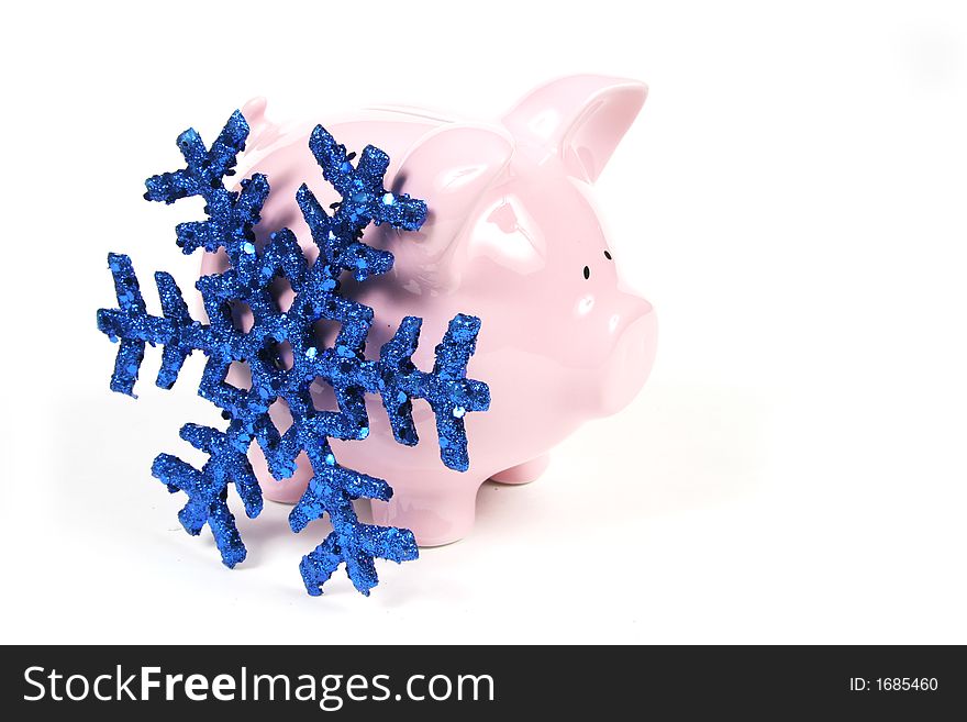 Pink Piggy Bank on isoalted on white background with blue snowflake. Pink Piggy Bank on isoalted on white background with blue snowflake