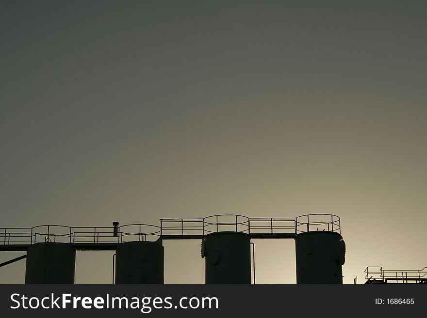 Silhouette Of Industrial Silos Tanks Within Polluted Air. Silhouette Of Industrial Silos Tanks Within Polluted Air