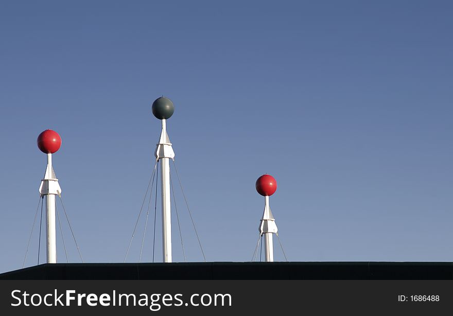 Three Rooftop Poles In Front Of Clear Blue Sky, Background