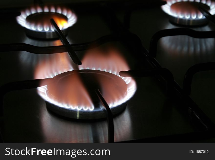 Blue Flame Of A Stove Burner In Darkness Illustrating Combustion Of Gas. Blue Flame Of A Stove Burner In Darkness Illustrating Combustion Of Gas