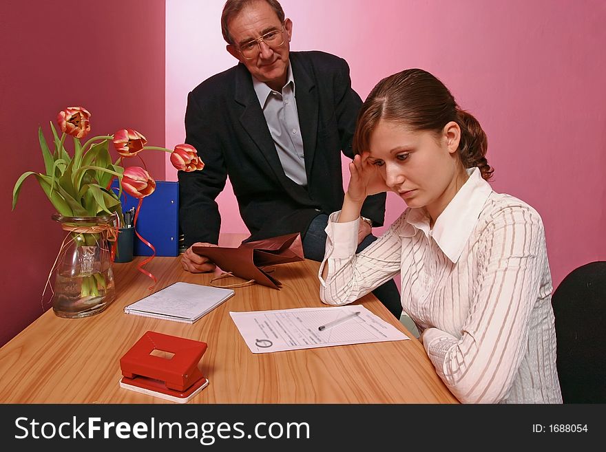 Work environment- man bringing some gift for a woman working in office