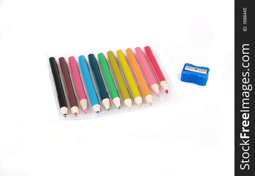 Short colored pencils in a plastic tray with a sharpener