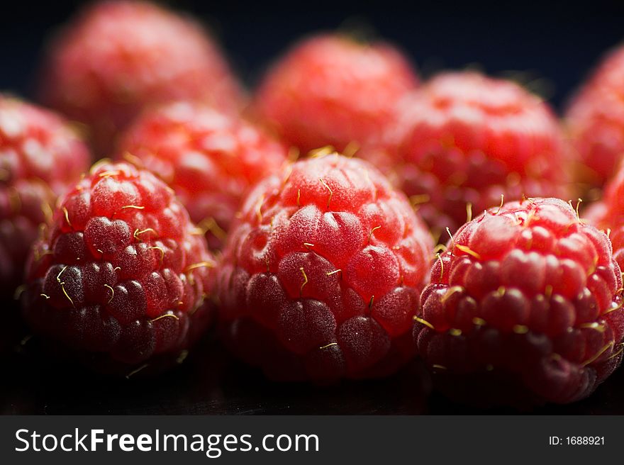 Deliciously fresh and tender raspberries macro with focus in front