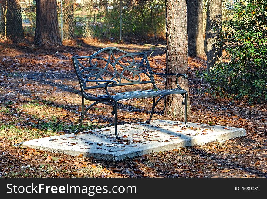 Wrought iron bench in park on winter day. Wrought iron bench in park on winter day