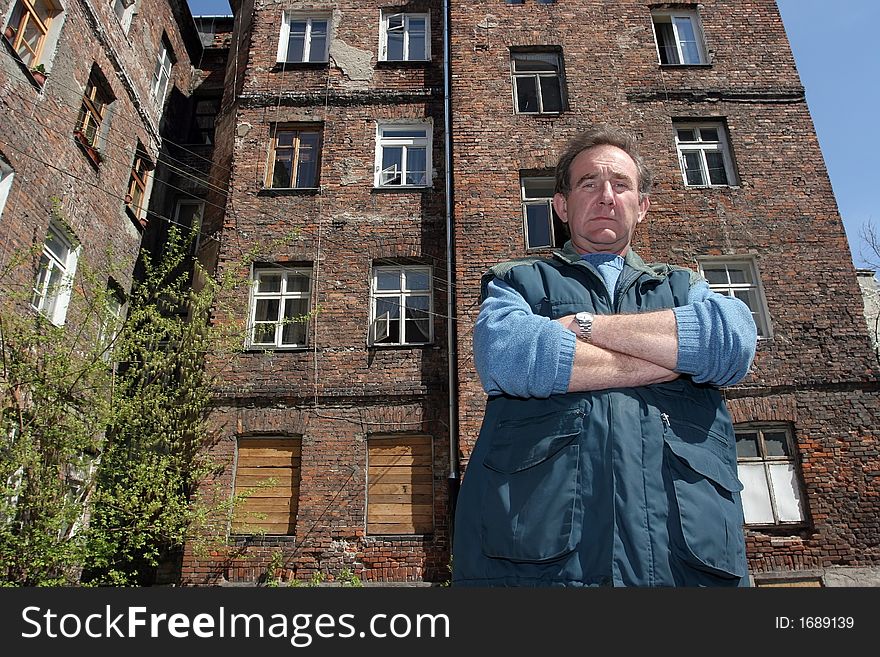 Man in front of  ruined tenement-house in Warsaw, Poland. Man in front of  ruined tenement-house in Warsaw, Poland
