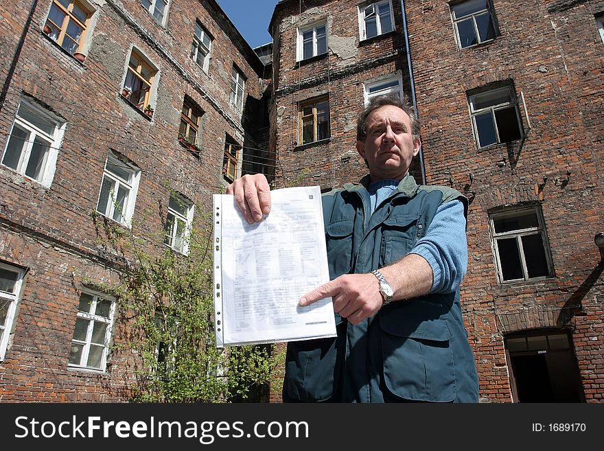 Man in front of  ruined tenement-house in Warsaw, Poland. Man in front of  ruined tenement-house in Warsaw, Poland