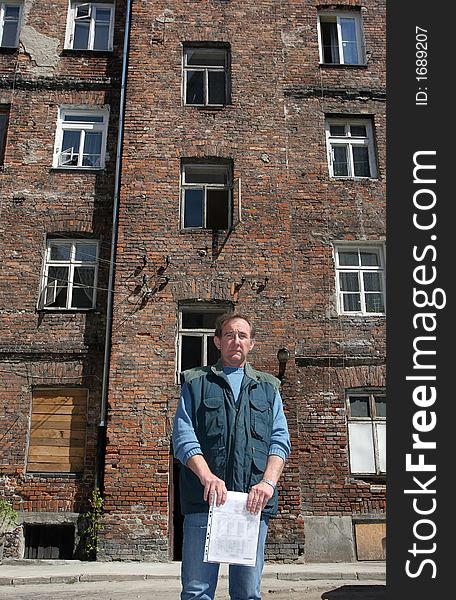 Man in front of ruined tenement-house in Warsaw, Poland. Man in front of ruined tenement-house in Warsaw, Poland