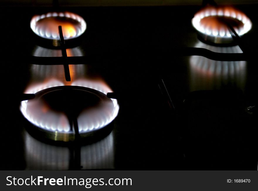 Blue Flame Of A Stove Burner In Darkness Illustrating Combustion Of Gas. Blue Flame Of A Stove Burner In Darkness Illustrating Combustion Of Gas