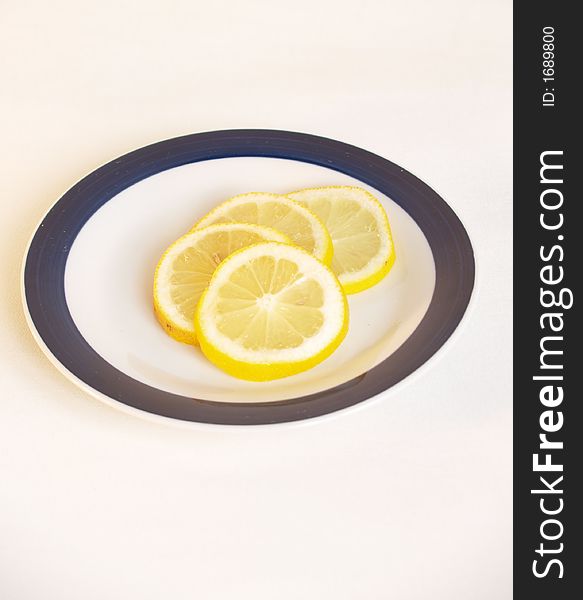 Fresh sliced lemon on a plate. Fresh sliced lemon on a plate