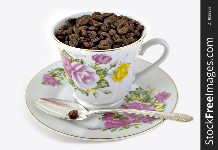 Coffee beans in a fance coffee cup on a white background. Coffee beans in a fance coffee cup on a white background