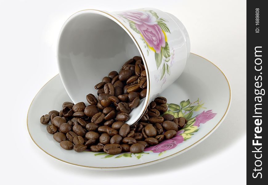Fancy coffee cup and coffee beans on a white background. Fancy coffee cup and coffee beans on a white background