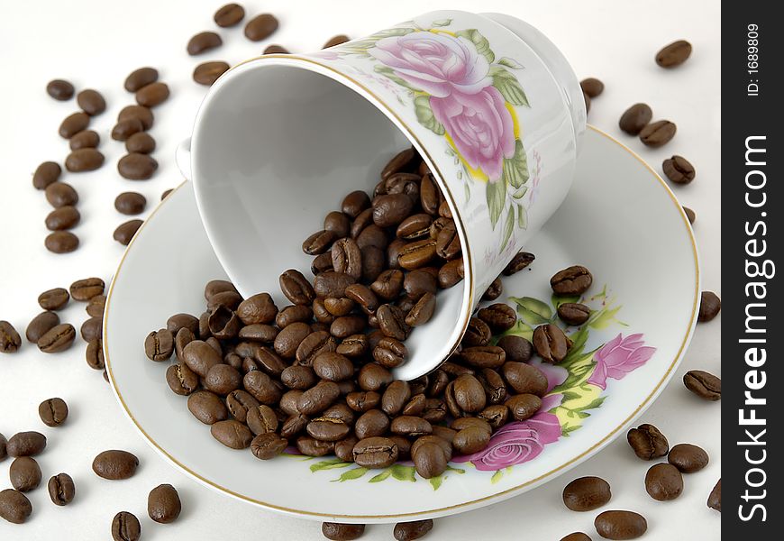 Fancy coffee cup and saucer with coffee beans. Fancy coffee cup and saucer with coffee beans