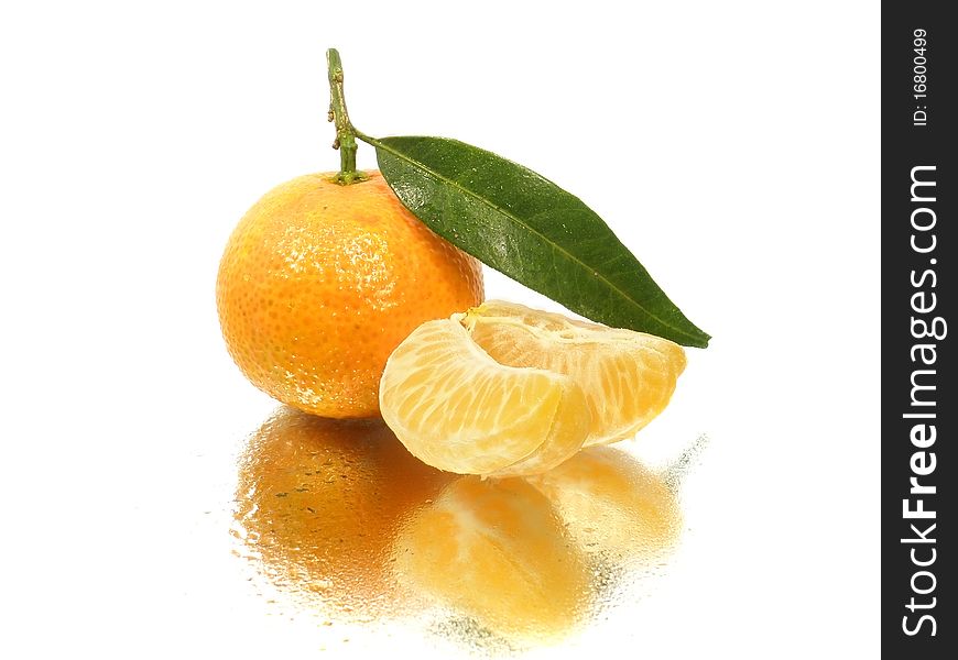 Tangerine with leave and slices on the white background with water drops. Tangerine with leave and slices on the white background with water drops