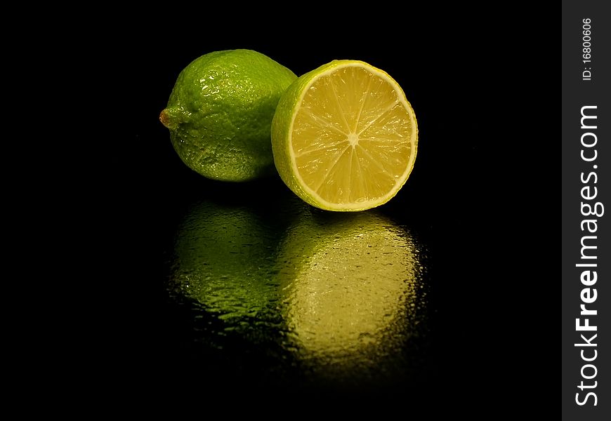 Citrus fruits on the white black with water drop