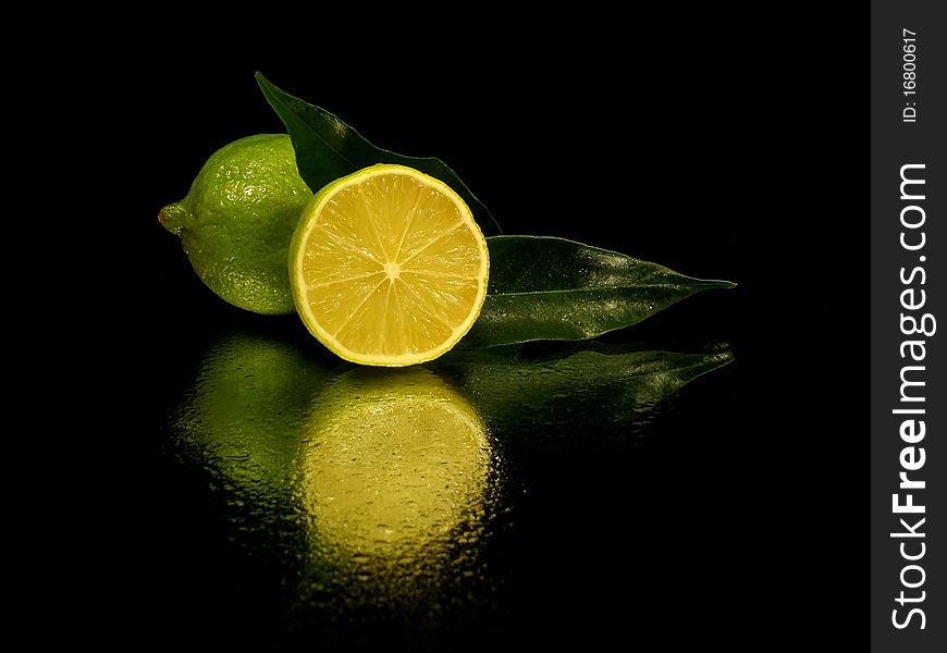 Citrus fruits on the white black with water drop