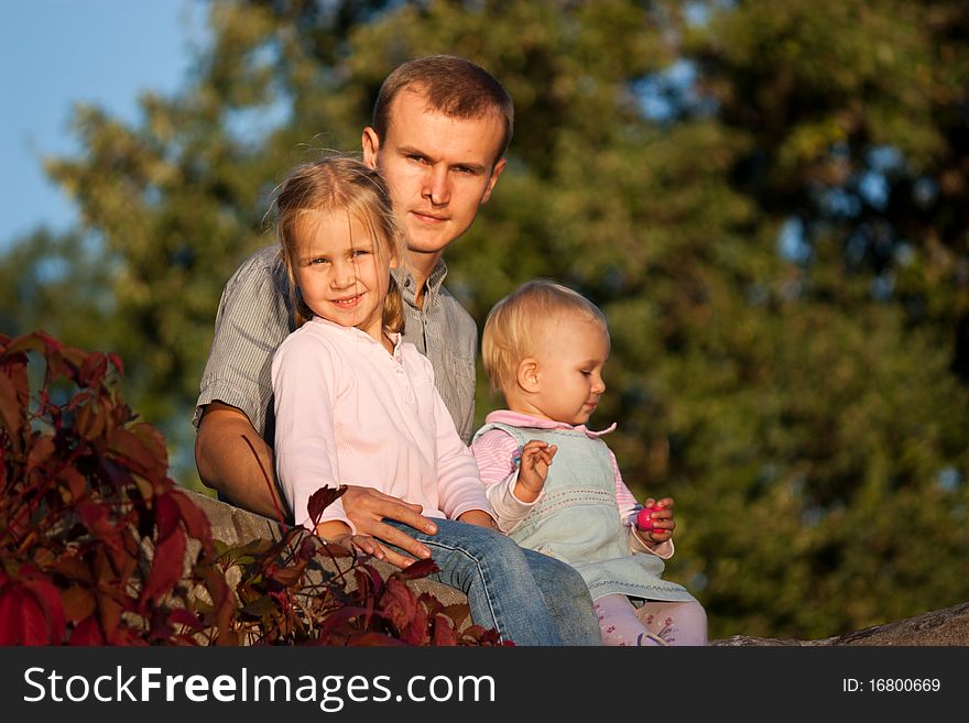 Father with two daughters in summer