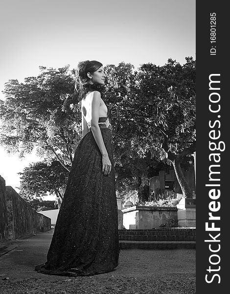 Model pose ona long dress at the park. Photo in black and white. Model pose ona long dress at the park. Photo in black and white.