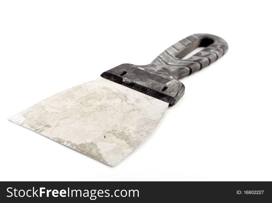 Isolated old and dirty palette knife for plaster walls